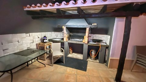 The built-in barbecue, lit for the evening