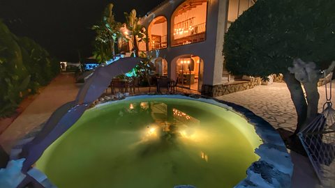 The fountain and rock pool, lit at night