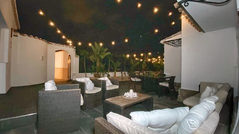 The lounge terrace under the string lights