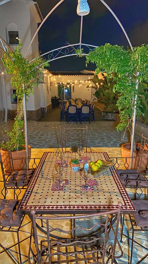 The mosaic table under the pergola at night