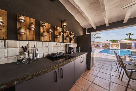 The outdoor kitchen with its range and prep bench