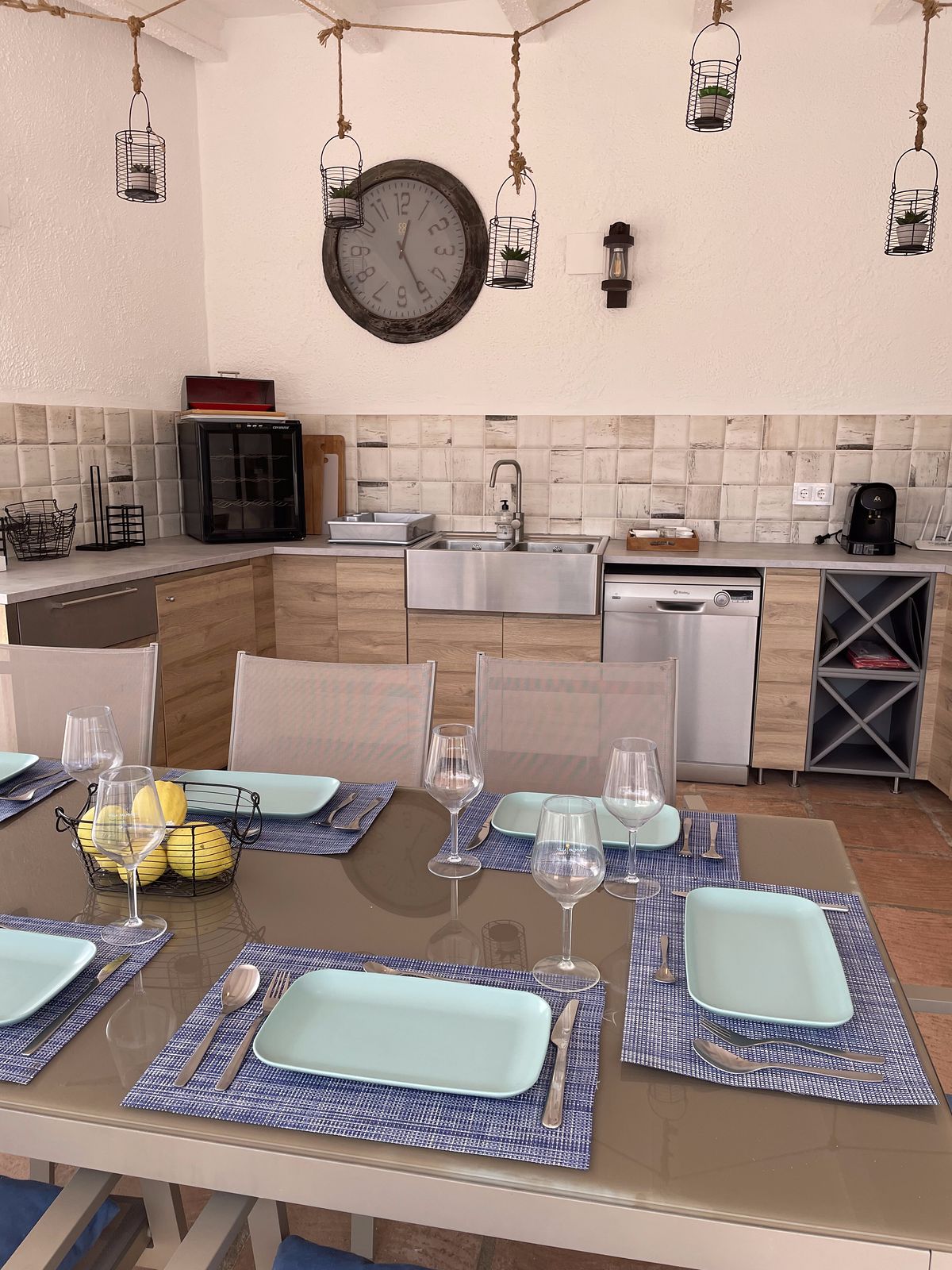 The outdoor kitchen with the table laid for the group