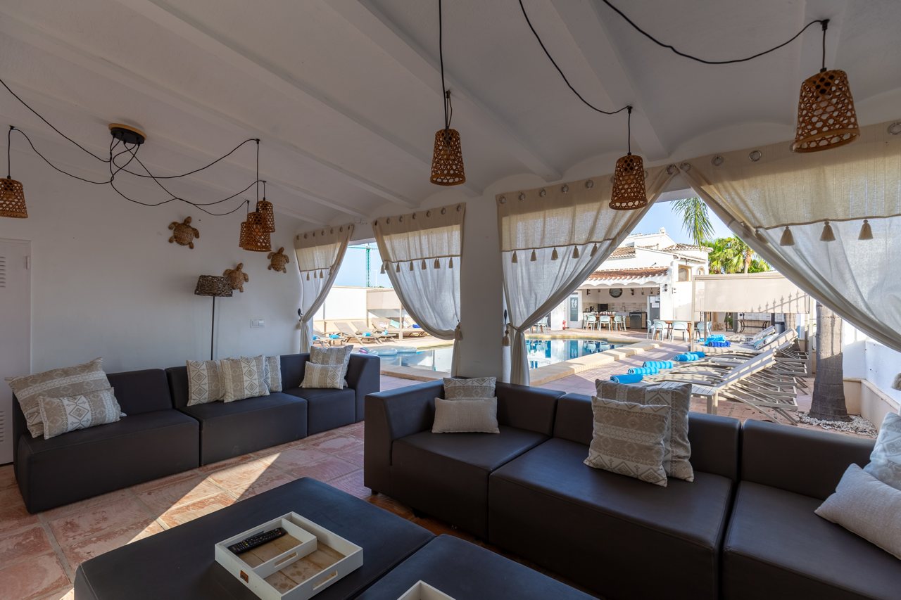 Curtained poolside cabana with lounge seating