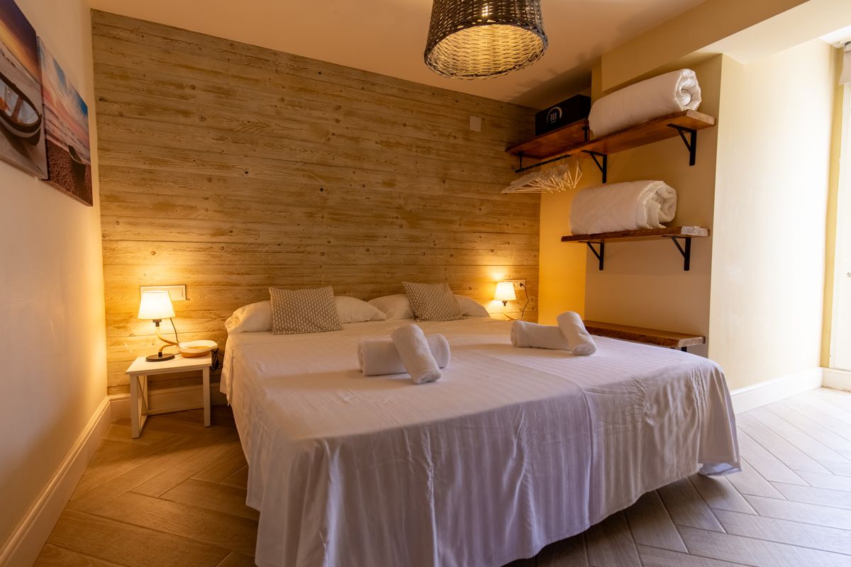 Bedroom with sea photographs above the bed — Nauticaa, wing one of Villa Palmview, Jávea