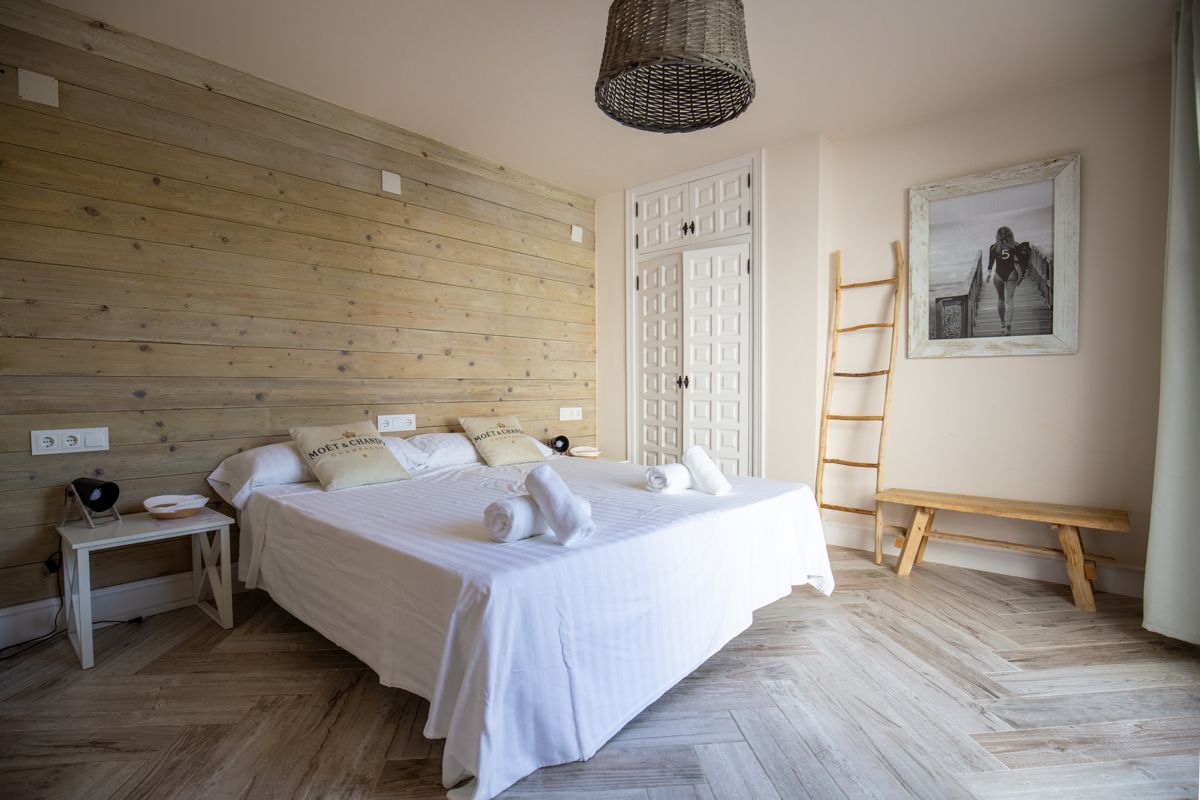 Bedroom with wooden wall and decorative ladder — 20,000 Leagues Under the Sea, wing two of Villa Palmview, Jávea