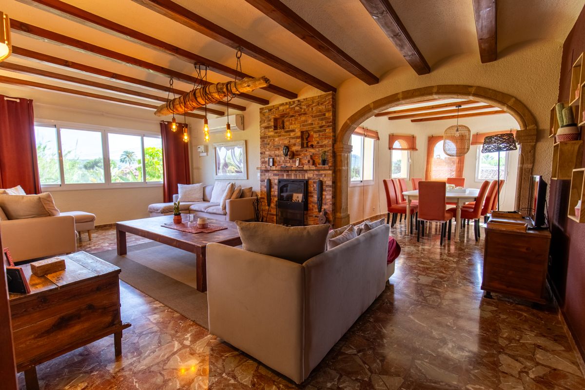 Woonkamer met balkenplafond en open haard — Mystique Travels, vleugel drie van Villa Palmview, Jávea