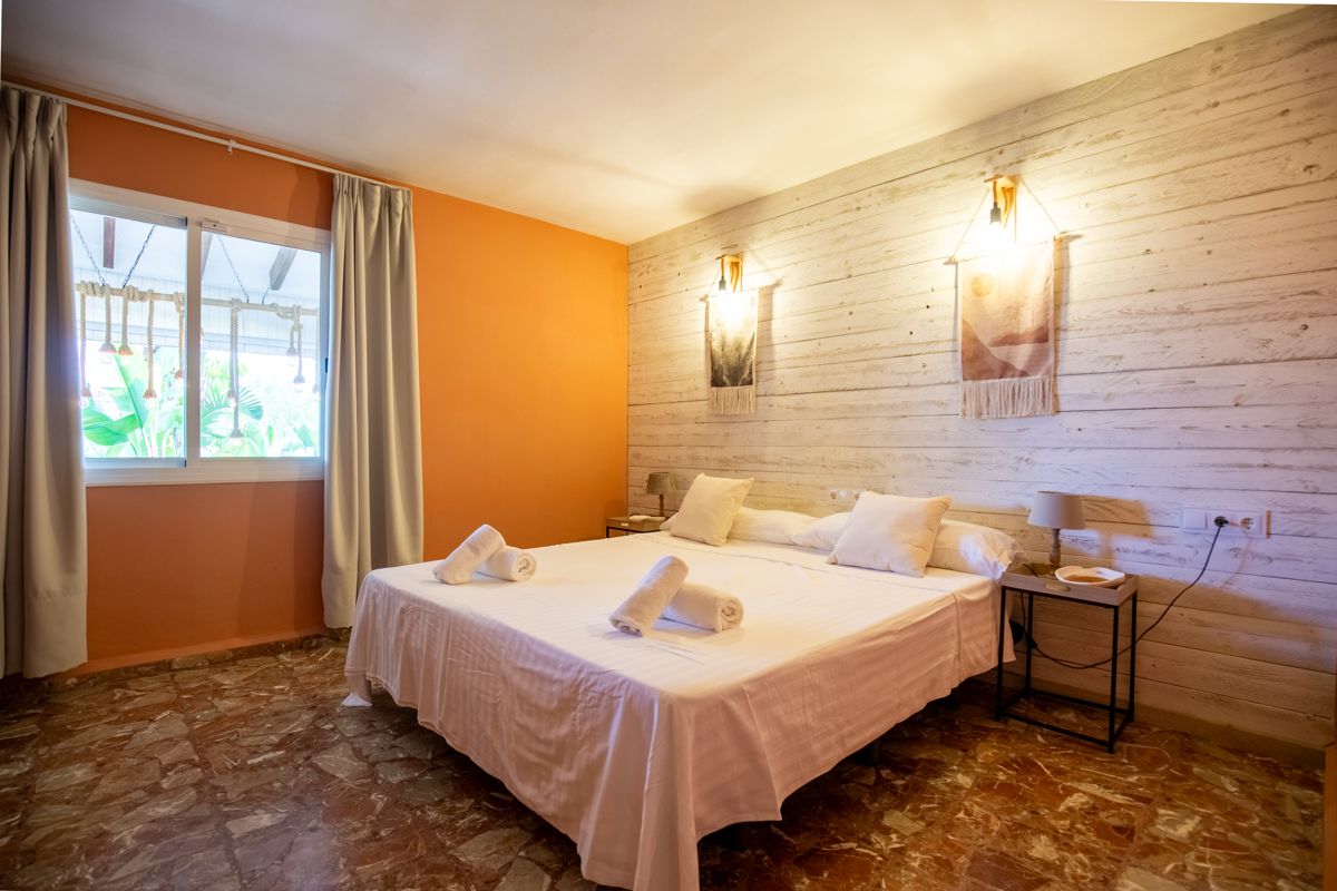 Bedroom with wooden wall and warm accent colour — Mystique Travels, wing three of Villa Palmview, Jávea