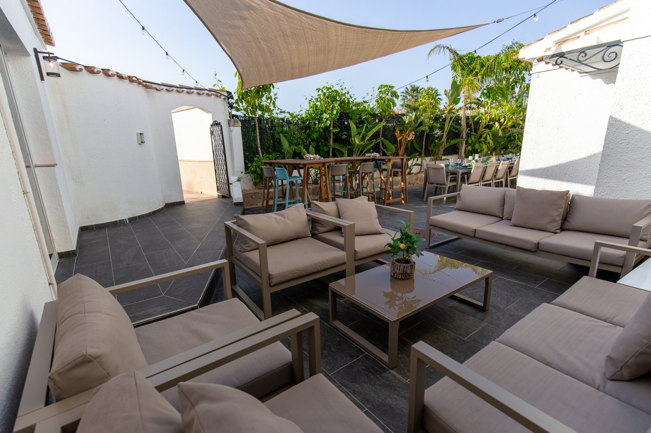 Outdoor lounge seating under a shade sail