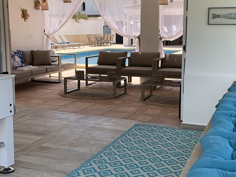 The pool-house lounge beside the water