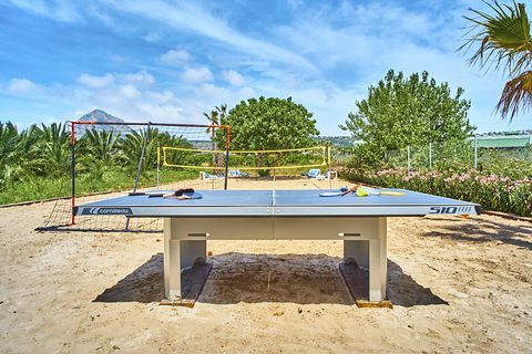 Table tennis and volleyball on the sand, the Montgó behind