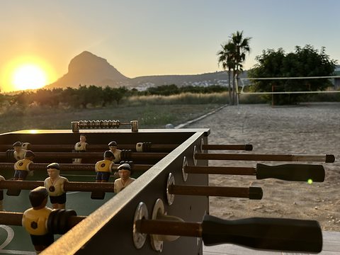 Table football at sunset, the Montgó on the horizon