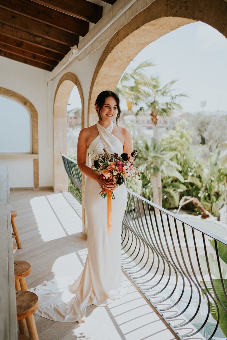 Bride on the arched balcony of Villa Palmview
