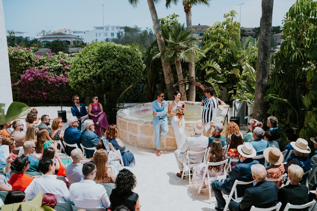 Wedding ceremony with seated guests in the villa gardens