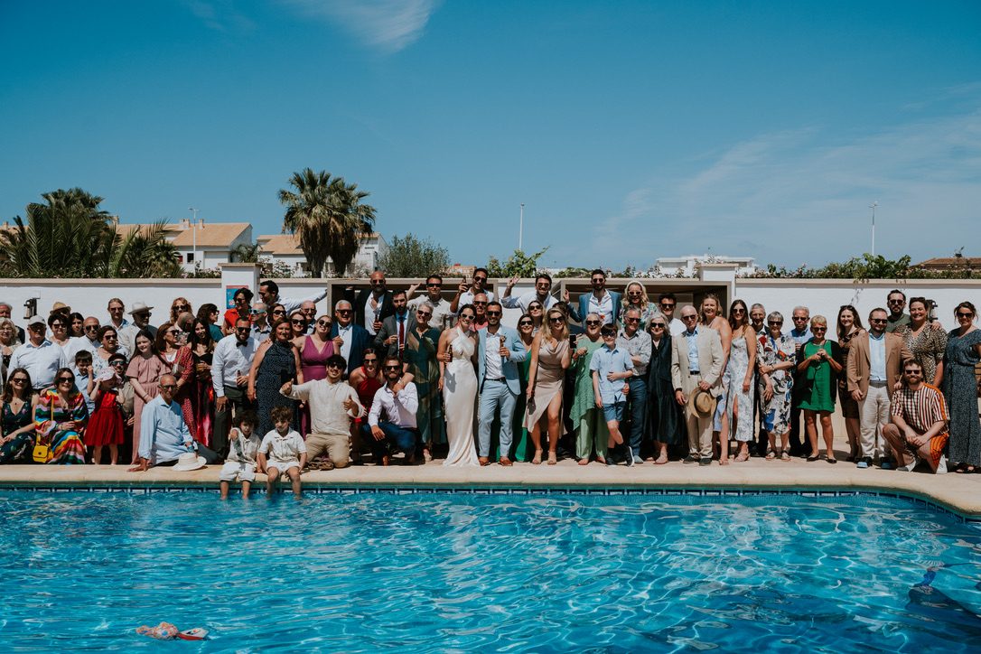 The whole wedding party gathered at the pool