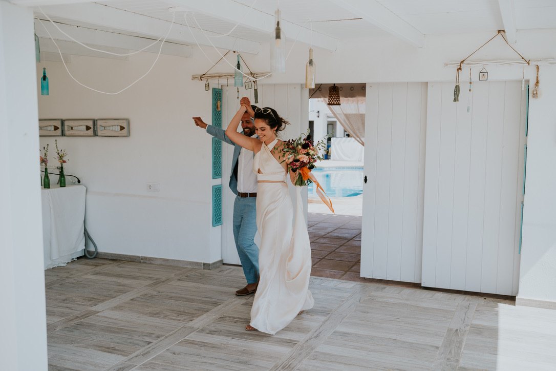 The bride dancing on the covered terrace of the pool house