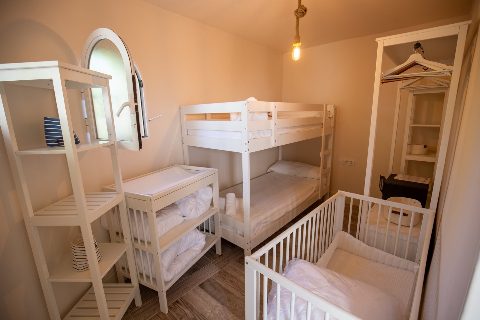 Children's room with bunk beds and a cot